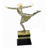 An Art Deco silvered bronze and ivory figure of a skater with arms outswept, on an onyx and slate