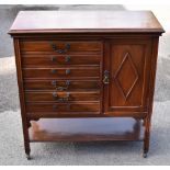 An Edwardian walnut music cabinet, with six drawers and a door above undertier, width 78cm.