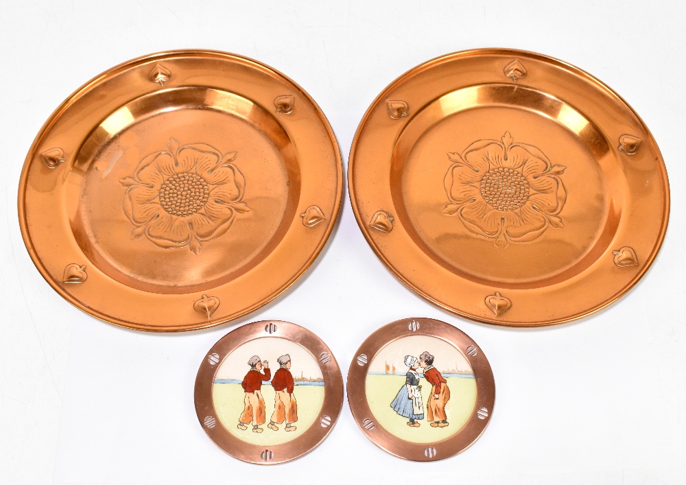 WMF; a pair of copper circular dishes embossed with Tudor Roses inside Art Nouveau flowerheads,