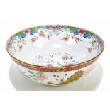 A large 18th century Chinese Famille Rose bowl, decorated with enamels depicting a central Dog of Fo