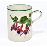 WEMYSS WARE; an oversized mug painted with fuchsia, impressed marks and retailer stamp for T.