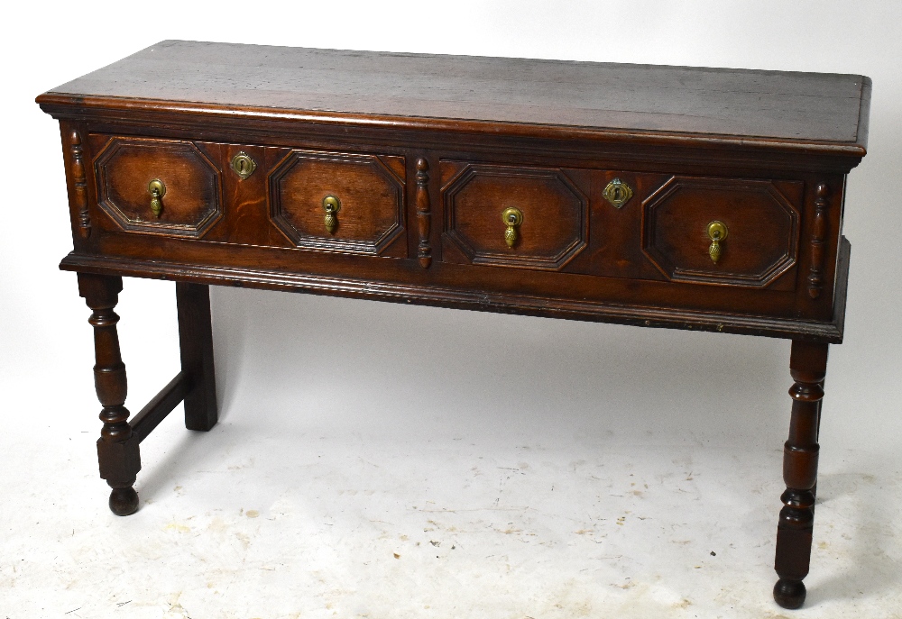 A 1920’s oak dresser base, of 17th century style, with two fielded drawers, on turned and block