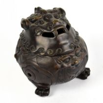 An early 20th century Chinese bronze globular incense burner with pierced mask cover, three paw feet