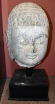 A large early Chinese carved stone head of Buddha on custom built contemporary stand, height