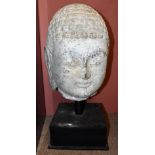 A large early Chinese carved stone head of Buddha on custom built contemporary stand, height