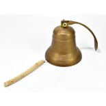 A brass wall mounted hanging bell, height 22cm.