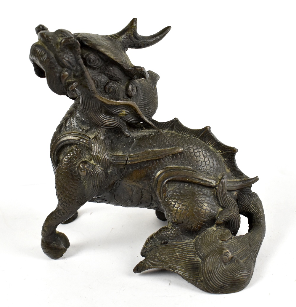 A 17th century Chinese bronze figure of a seated mythical beast, height 13cm. Provenance: private