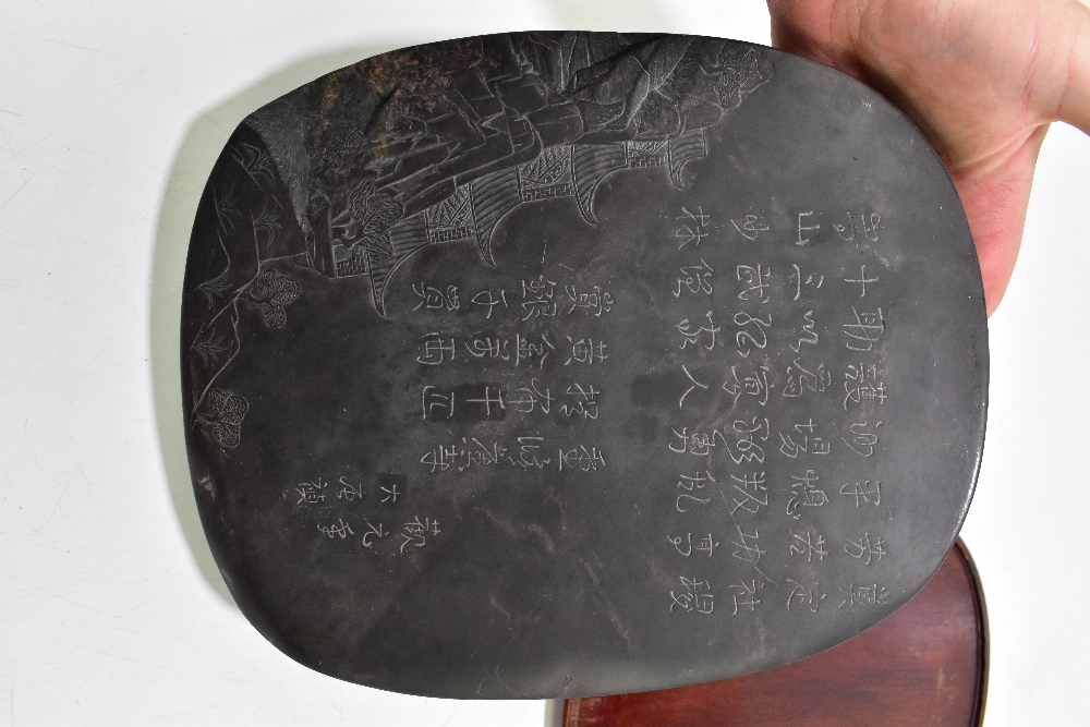 A Chinese Qing Dynasty duan ink stone, with incised details to the underside, and with wooden base - Image 3 of 4