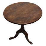 A 19th century oak tilt-top tripod table, height 70cm, diameter of top 65cm.