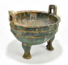 A Chinese Han Dynasty (206 BC - 220 AD) bronze twin handled tripod vessel, height 21cm, width