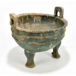 A Chinese Han Dynasty (206 BC - 220 AD) bronze twin handled tripod vessel, height 21cm, width