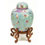 A late 19th century Chinese Famille Rose jar and cover, enamel painted with floral sprays on a