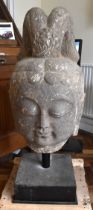 A very large and early Chinese carved stone head of Buddha on substantial custom made stand,