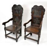 A  pair of 19th century oak Wainscot chairs, the carved panel backs inset with initials 'KE 1662'