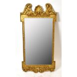 An ornate gilt metal framed wall mirror with bevelled plate, height 94cm, and a smaller