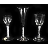 Three 19th century wine glasses comprising a conical bowl glass with double opaque twist stem,