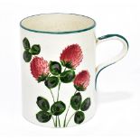 WEMYSS WARE; an hand painted oversized mug decorated with a flowering pink clover beneath a green