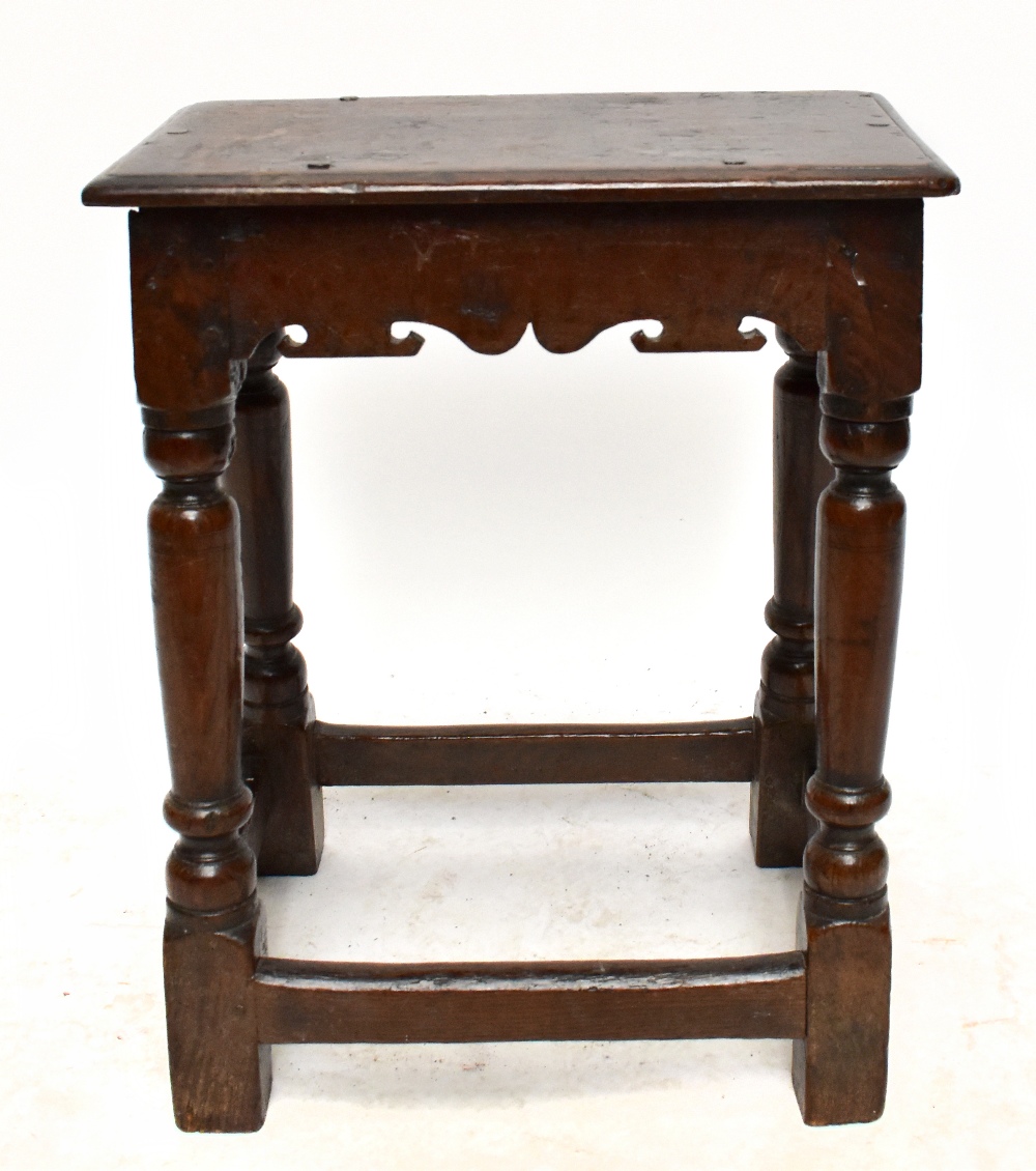 An 18th century oak joint stool of rectangular form, on block feet, height 55cm, depth 27.5cm, width