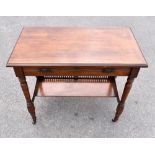 An Edwardian walnut writing desk with hinged lid, fall down front, raised on turned legs united by a