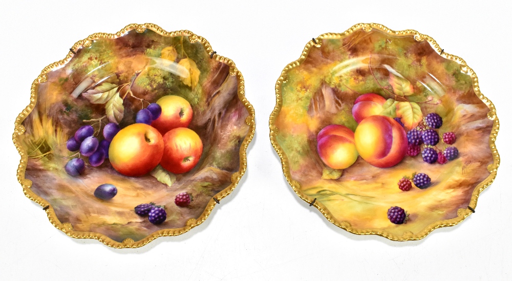 HORACE PRICE FOR ROYAL WORCESTER; a pair of hand painted cabinet plates with scalloped edges