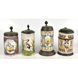 Four 18th century German faïence steins with hinged covers, one decorated with a crane and