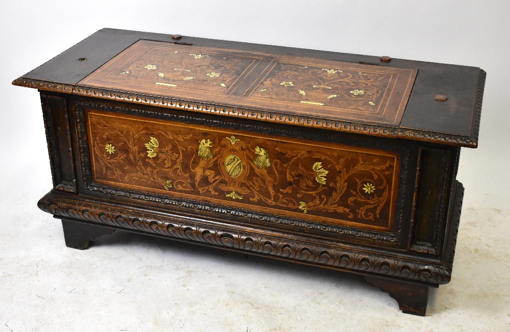 A 19th century Italian carved oak, marquetry and ivory inlaid cassone, the top and front panel