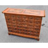 A modern Chinese carved hardwood medicine chest, with an arrangement of thirty-six drawers, on