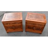 A pair of modern Chinese carved hardwood bedside cabinets, with one drawer and two cupboard doors,