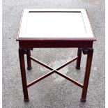 A reproduction bijouterie table, the hinged top inset with bevelled glass, 56 x 47cm.