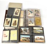 A large collection of early 20th century and later British and world postcards in four albums, to