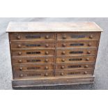 An interesting Victorian stained pine chest of twelve drawers, each stencilled with a month of the