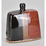 JAMES HAKE (born 1979); a rectangular stoneware bottle covered in tenmoku, kaki and copper red