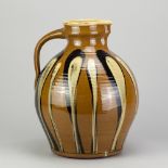 PAUL BARRON (1917-1983); a large slipware bellied jug with yellow and black decoration on tan