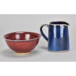 Dartington Pottery; a small stoneware jug covered in vibrant blue glaze, impressed pottery mark,