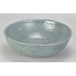 NORAH BRADEN (1901-2001); a large stoneware bowl covered in blue/grey glaze, inscribed in pencil '