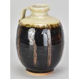 JIM MALONE (born 1946); a stoneware bottle with side handle partially covered in tenmoku breaking to