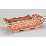 WAYNE CLARK; a rectangular wood fired stoneware footed dish covered in shino glaze, impressed WC