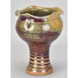 ADRIAN LEWIS-EVANS (1927-2021); a stoneware chalice with wavy rim partially covered in copper red