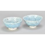 PETER WILLS (born 1955); a near pair of grogged porcelain bowls covered in pale blue glaze,