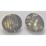 KATRINA TRINICK (born 1950); a pair of stoneware pebble forms with deeply incised decoration,