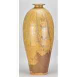 JIM MALONE (born 1946); a very tall stoneware bottle covered in ash and granite glaze over ochre