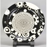 MARK DALLY (born 1958); an earthenware charger covered in a black and white design, slip trailed MWD