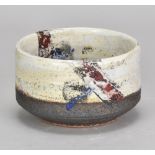 ROBIN WELCH (1936-2019); a stoneware bowl with textured surface covered in bands of white and bronze