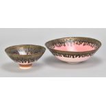 PETER WILLS (born 1955); a porcelain bowl covered in bright pink glaze with bronze running from