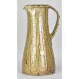 JIM MALONE (born 1946); a large stoneware pitcher covered in green ash clay glaze with incised