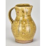 PHIL ROGERS (1951-2020); a stoneware jug covered in green ash glaze with incised decoration,