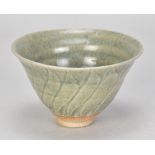 KATHARINE PLEYDELL-BOUVERIE (1895-1985); a stoneware bowl covered in green ash glaze with incised