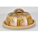 MIKE DODD (born 1943); a large cut sided stoneware cheese dome and plate covered in granite and iron