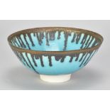 PETER WILLS (born 1955); a porcelain bowl covered in turquoise glaze with bronze running from the