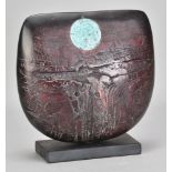PETER HAYES (born 1946); a raku bow with fractured red surface and copper patina disc mounted on